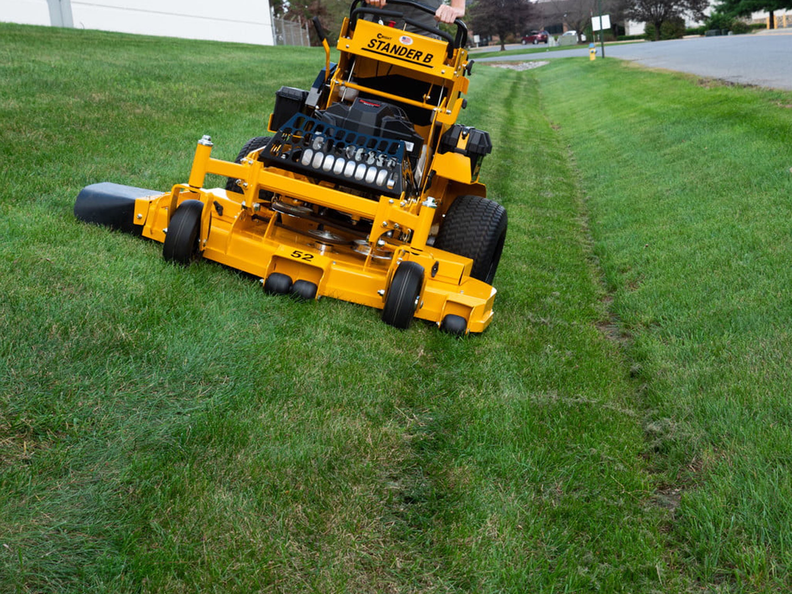 COX Commercial Mowers The Stander® B Stand on mower photo of front of mower with someone mowing their lawn